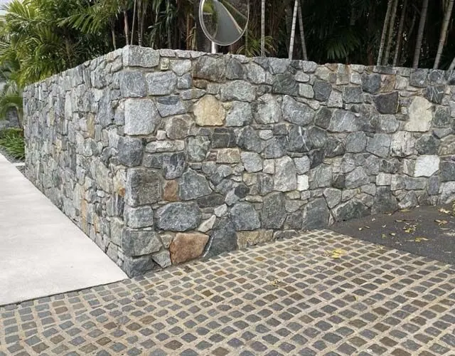 Natural stone retaining wall by All Stone & Pave