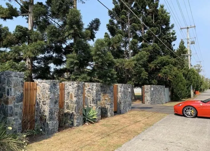 Natural stone retaining wall by All Stone & Pave