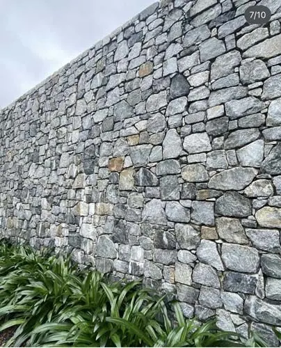 Natural stone retaining wall by All Stone & Pave