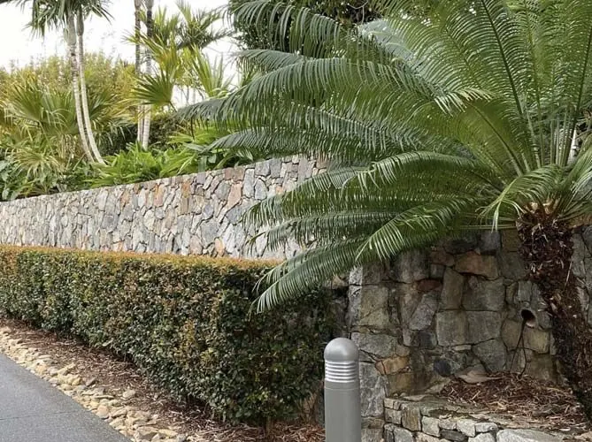 Natural stone retaining wall by All Stone & Pave