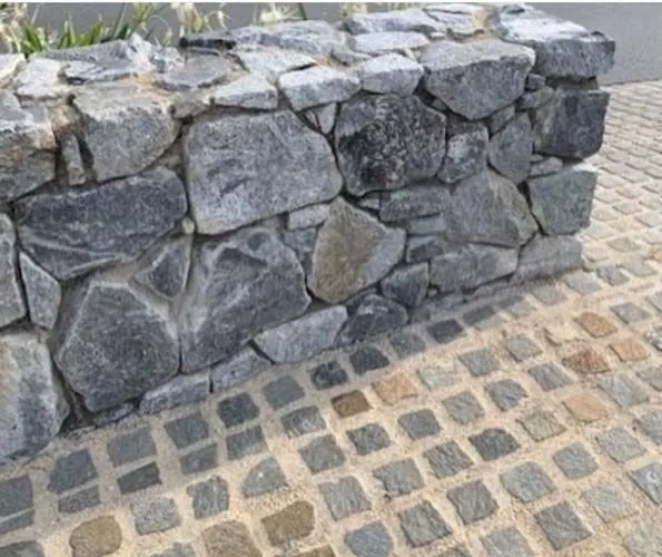 Natural stone retaining wall by All Stone & Pave