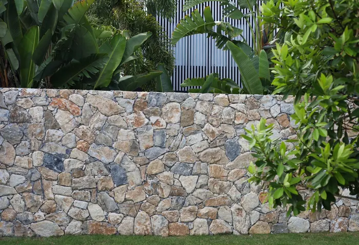 Natural stone retaining wall by All Stone & Pave