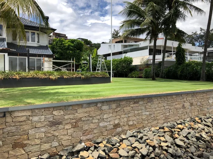 Natural stone retaining wall by All Stone & Pave