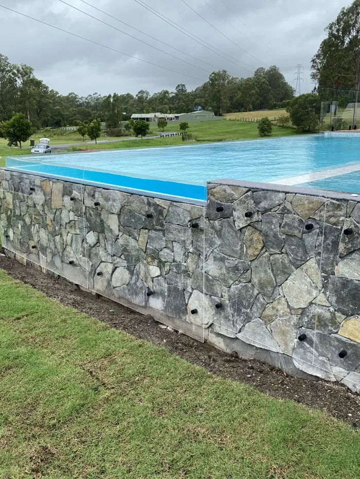 Natural stone retaining wall by All Stone & Pave