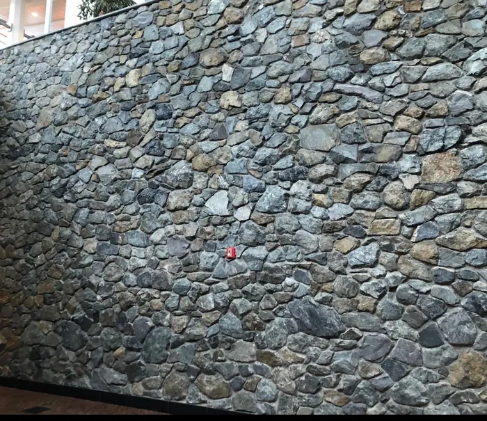 Natural stone retaining wall by All Stone & Pave